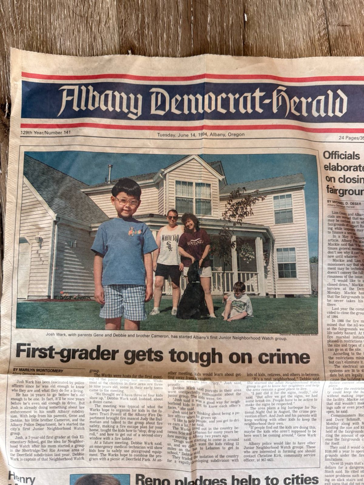 Albany Democrat-Herald front page from June 14, 1994. Headline: First-grader gets tough on crime. Seven-year-old Josh Wark stands in front of his family's house with his parents and younger brother.