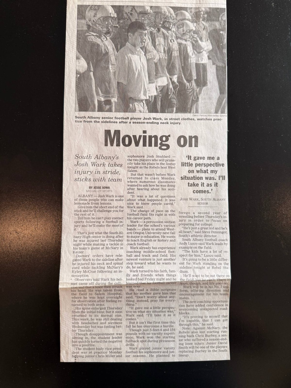 Mid-Valley Sports clipping from fall 2004. Headline: Moving on. South Albany senior Josh Wark, in street clothes, watches football practice from the sideline after a season-ending neck injury.