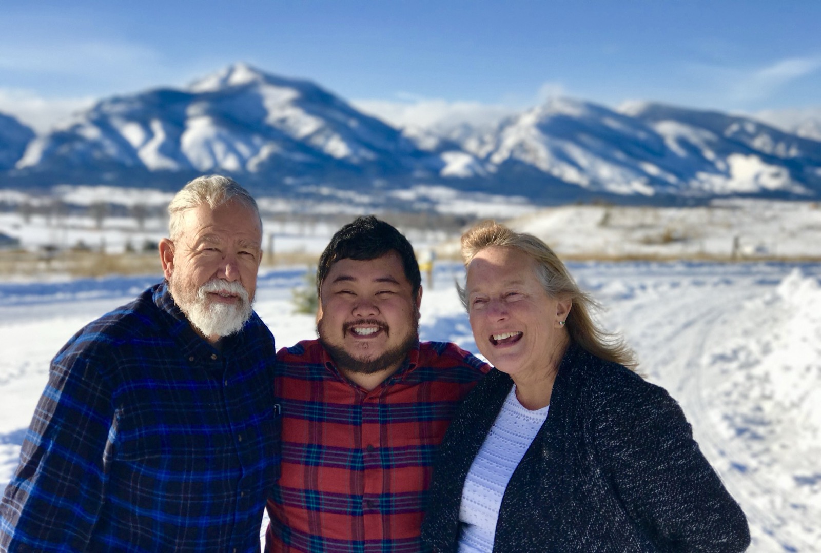Josh Wark with family in front of snowy mountains